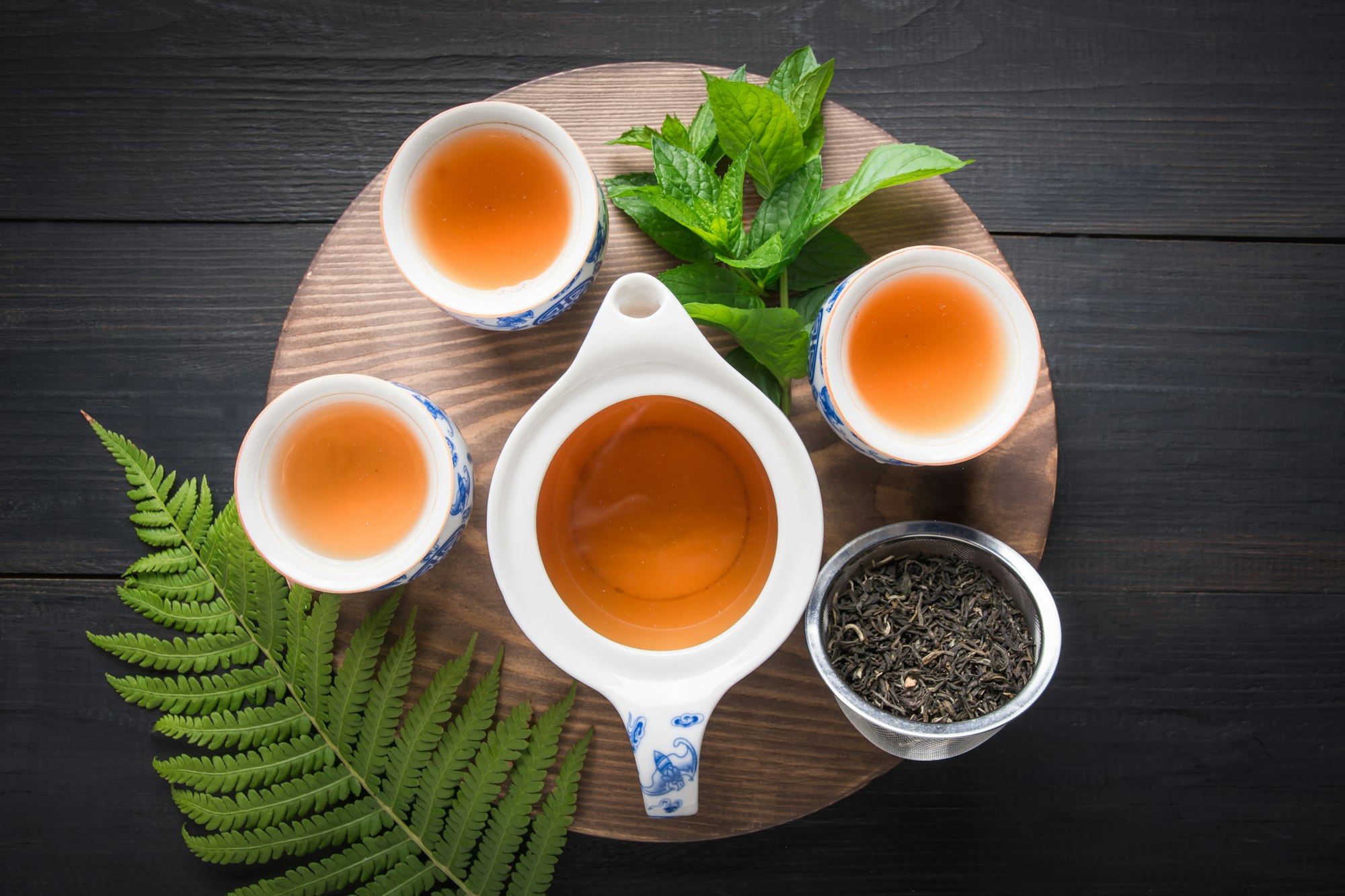 Tea ceremony. Three cup of tea with mint and kettle . Chinese tea concept.